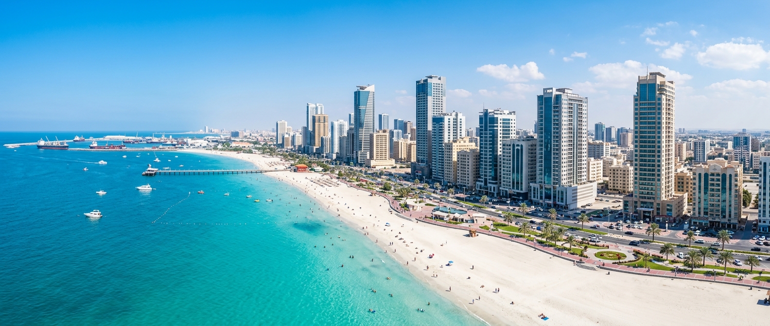 Panoramic view of Ajman city skyline with pristine white sand beaches, turquoise Arabian Gulf waters, modern high-rise buildings, and the Ajman Corniche under bright sunshine